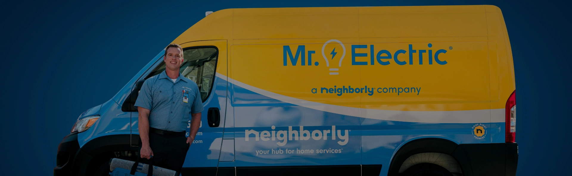 A Smiling Mr. Electric Electrician in a Yellow Mr. Electric Van Waves His Arm Out of the Open Driver-Side Window 